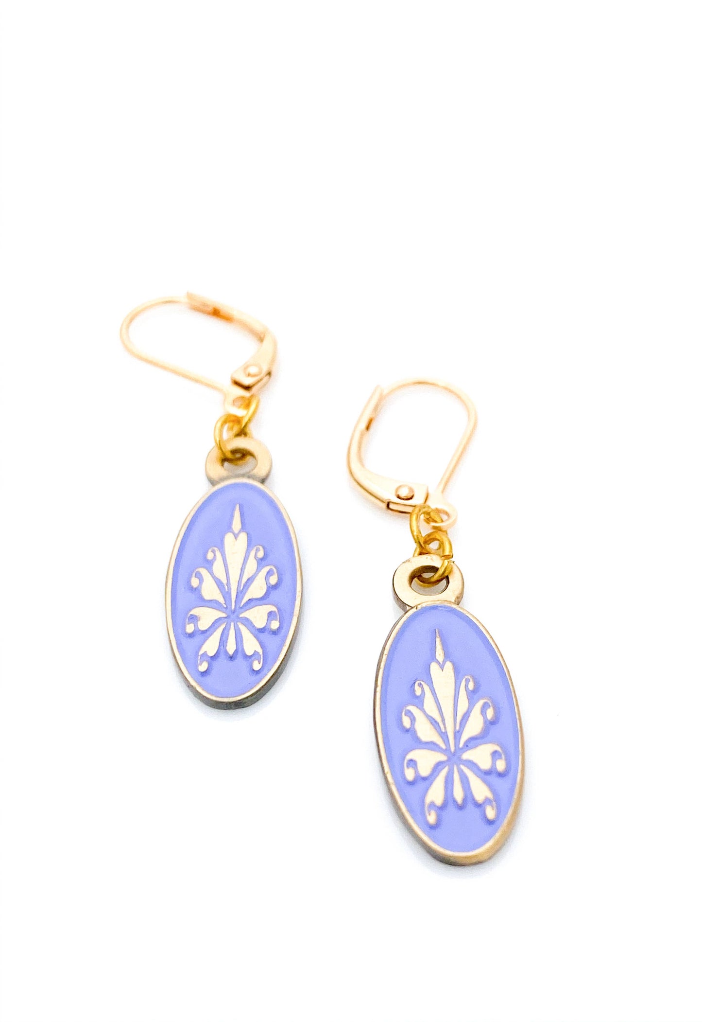 Antiqued gold oval earrings with fleur de lys pattern on lilac enamel