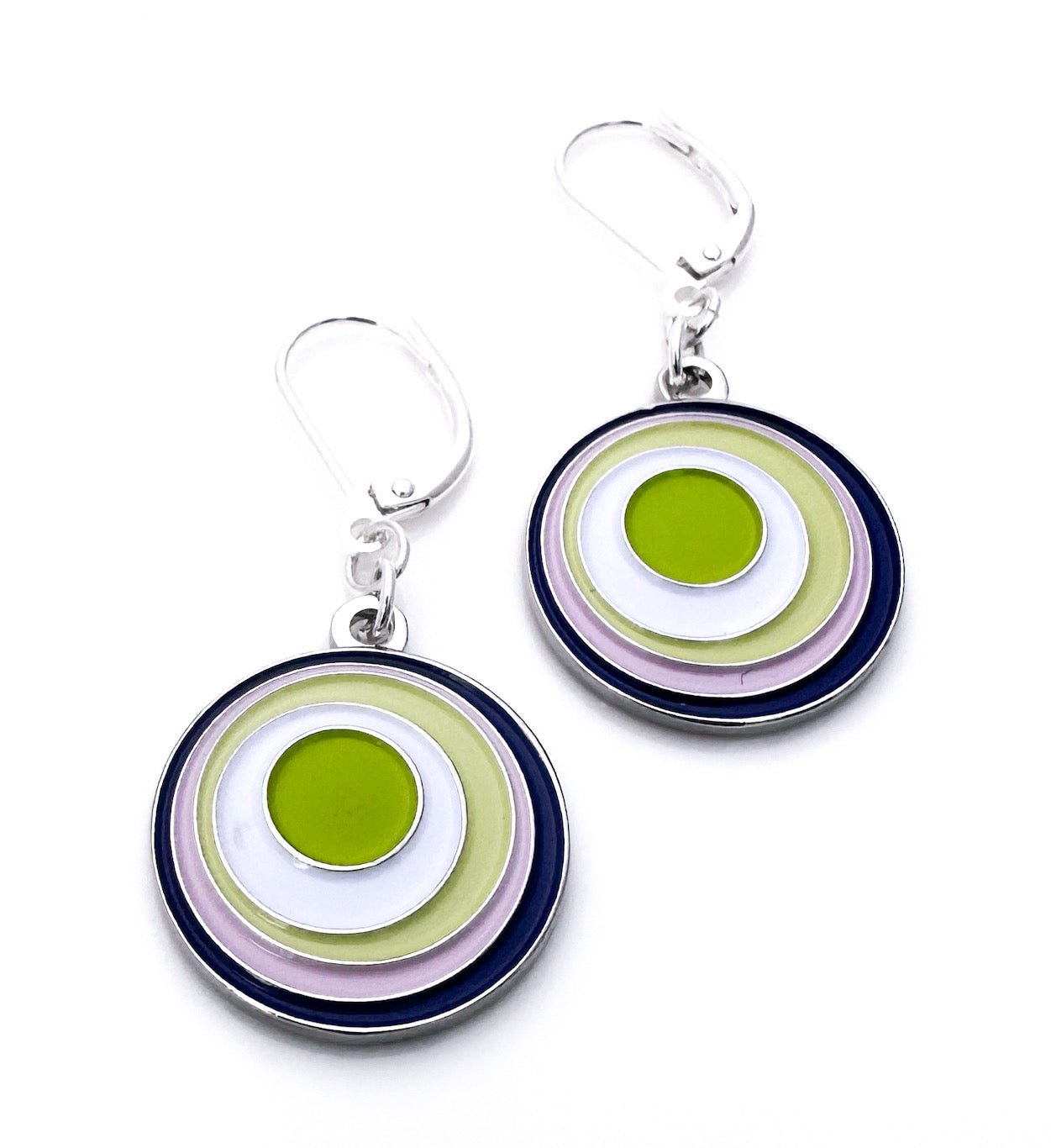Pair of circular earrings with green, white, and purple concentric circles on a white background.