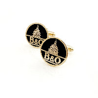 Gold and black cufflinks with 'B&O' logo on a white background