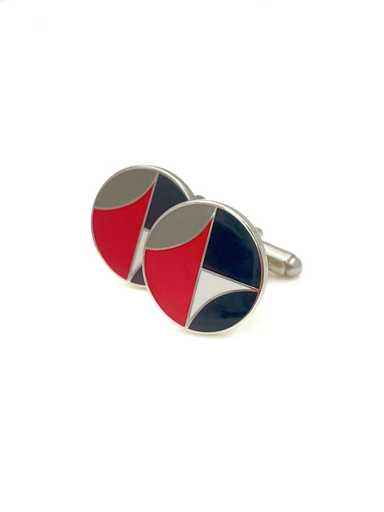 Cufflinks with red, black, and silver design on a white background