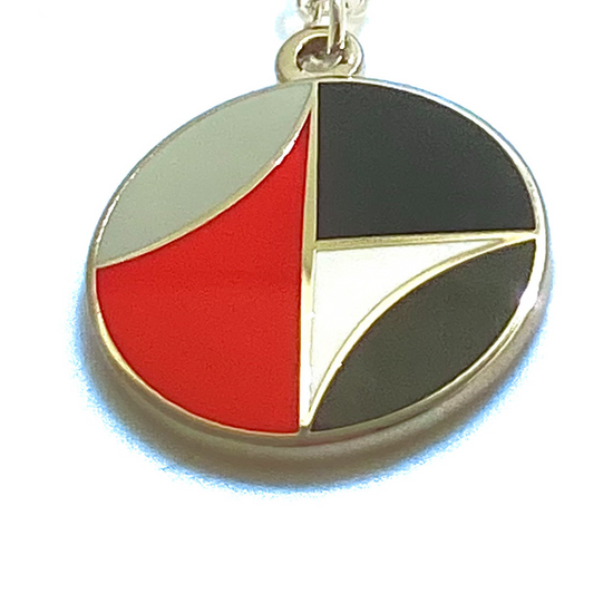 Colorful circular pendant with geometric design on a white background