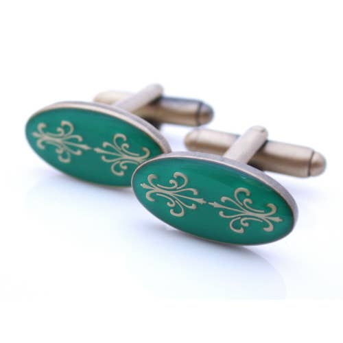 Antiqued gold oval cufflinks with two fleur de lys back to back on green enamel