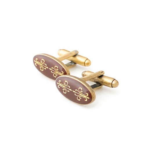 Antiqued gold oval cufflinks with two fleur de lys back to back on brown enamel