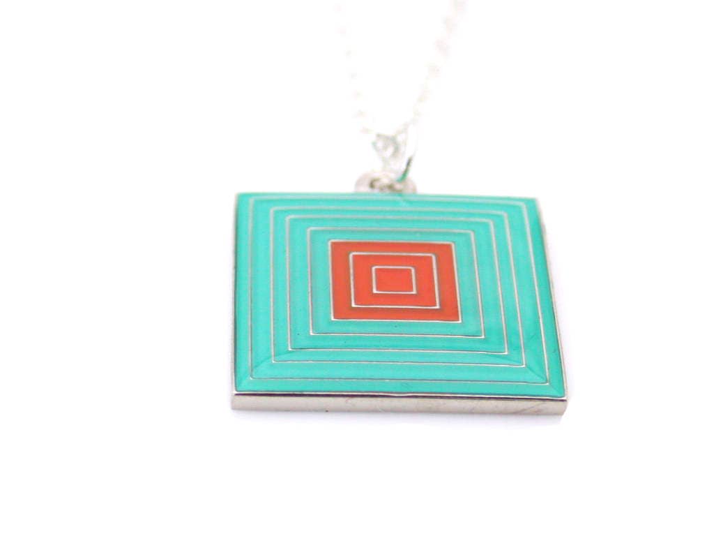 Necklace with a pattern of squares within squares green and orange enamel
