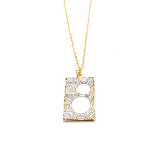 Gold and silver rectangular pendant with thin lines and curved
