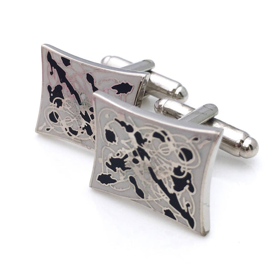 Cufflinks with a splatter design in cream and black