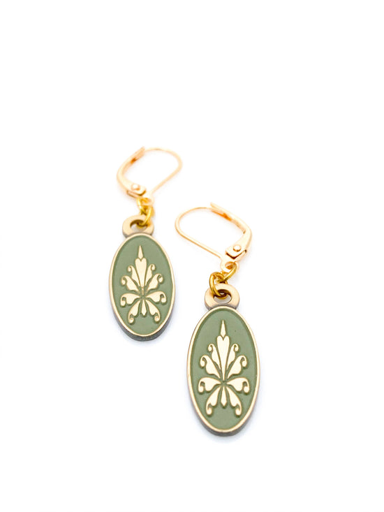 Antiqued gold oval earrings with fleur de lys pattern on green enamel