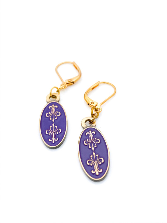 Antiqued gold oval earrings with two fleur de lys back to back on purple enamel