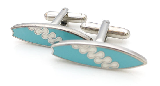 Surfboard shaped cufflinks in blue enamel with a squiggle pattern