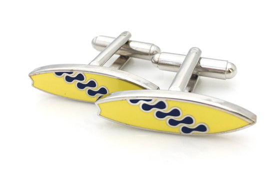 Surfboard shaped cufflinks in yellow enamel with a squiggle pattern